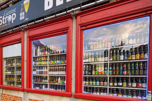 Many bottles in a window of alcohol store. Blurred