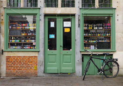 Beer Store's Window in Ghent, Belgium. Beer in Belgium varies from pale lager to amber ales, lambic beers, Flemish red ales, sour brown ales, strong ales and stouts. There are approximately hundreds of active breweries in Belgium.