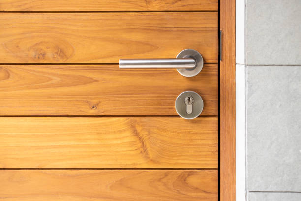 Stainless steel door handle and wooden door Stainless steel door handle and wooden door doorknob photos stock pictures, royalty-free photos & images