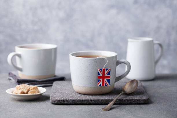 istock Tea in mugs with British flag tea bag label. Grey background. Copy space. 1172108737
