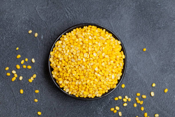 istock Yellow lentil in a black bowl on grey stone background. Top view. Copy space. 1172109454