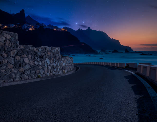Road over the ocean at night.