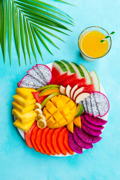 istock Tropical fruits assortment with mango smoothie, juice. Blue background. Top view. 1172110076