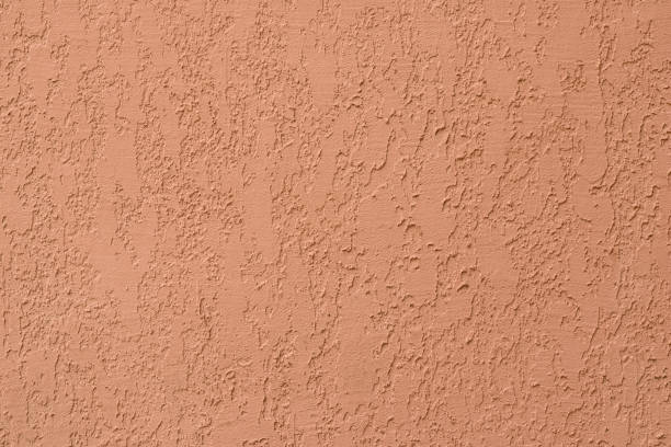 istock Light brown ribbed surface of stucco on concrete wall. Orange paper texture. Abstract pattern with embossed. Background with ornament. 1172113162