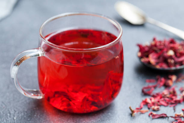 istock Hibiscus tea in glass cup. Grey background. Close up. 1172114338