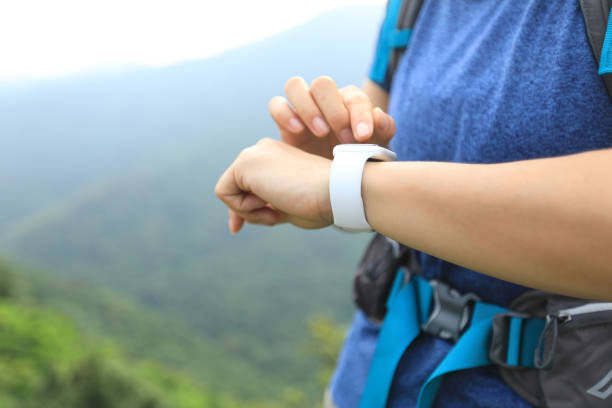 istock Woman hiker checking on smartwatch on mountain top 1172115495