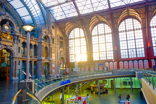 Antwerp, Belgium - June 2019: Internal facade in the Interior of Antwerp Central Train station with sun shining through the glass windows