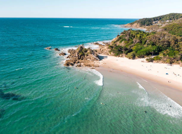 Aerial view of the pass in Byron bay during a nice afternoon with many surfers, swimmers and surfers. Aerial view of the pass in Byron bay during a nice afternoon with many surfers, swimmers and surfers. byron bay stock pictures, royalty-free photos & images