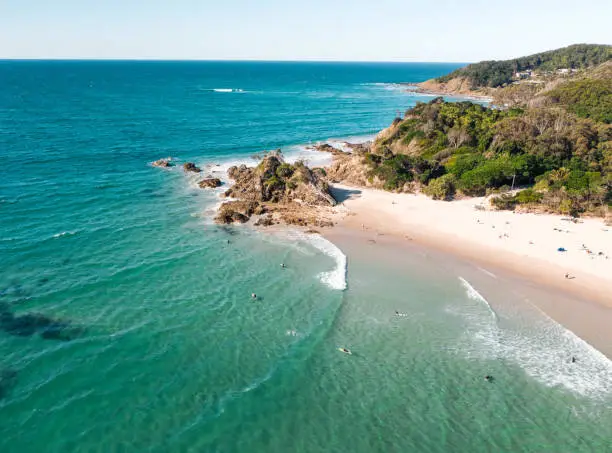 Photo of Aerial view of the pass in Byron bay during a nice afternoon with many surfers, swimmers and surfers.