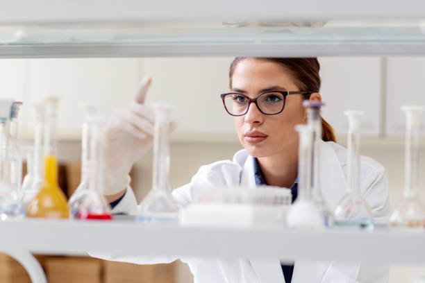 istock Woman in white uniform in laboratory work on analize 1172120312