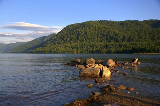 istock A stone ridge leaving in a mountain lake at sunset. 1172120979