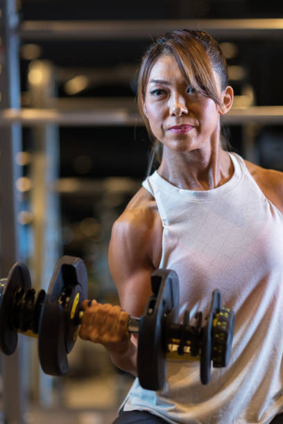 istock Middle aged woman training in a personal training gym 1172122086