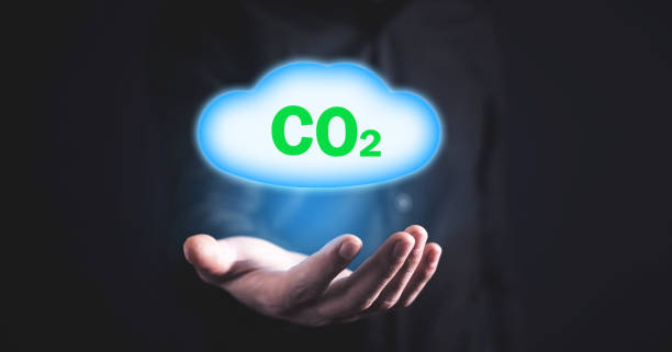 istock Man holding symbol CO2 with cloud. 1172124289