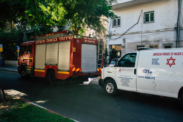 colors of Israel Tel Aviv Israel August 24, 2019 View of Israeli ambulance and fire engine parked in the streets of Tel Aviv in the afternoon ambulance in israel stock pictures, royalty-free photos & images