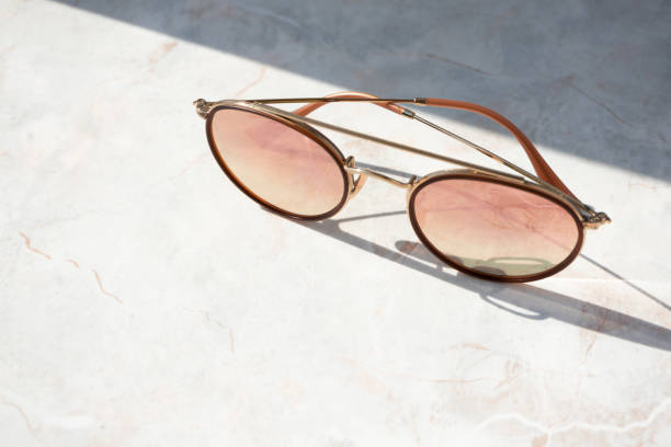 istock Chic female sunglasses on light marble background in natural light 1172129381