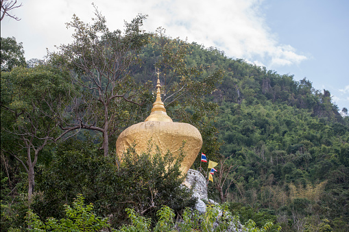 a golden rock at the Wat Phra That In Khaen Temple near the city of  Phrae in the north of Thailand.  Thailand, Phrae November, 2018.
