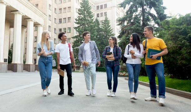 istock Happy students walking outside the university building 1172135479
