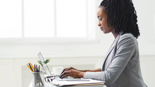 istock Young Afro Woman Working On Laptop Computer At Workplace 1172135501