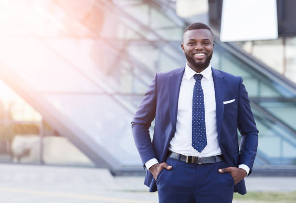 istock Happy Afro Businessman Smiling At Camera Standing Against Modern Building 1172136766
