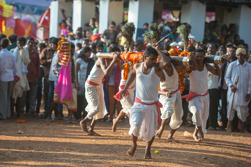 Tribal Devotee carrying God idos on shoulders during Dussera Procession near Jagdalpur,Chattisgarh,India,Asia