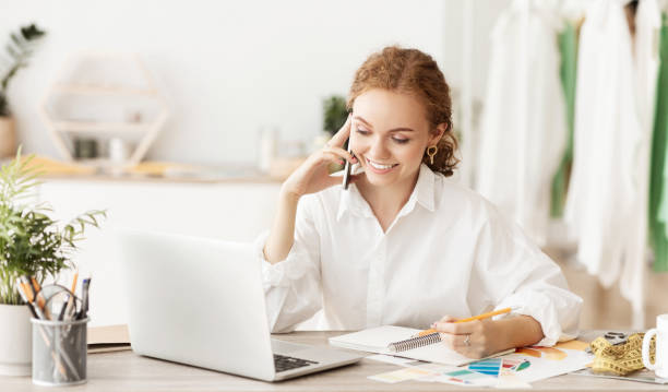 Fashion designer ordering fabric, talking on phone