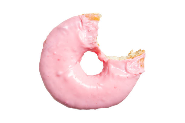 Top view of pink strawberry donut with bite missing isolated on white background