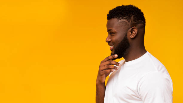 istock Black guy thinking about something and looking at free space 1172137200