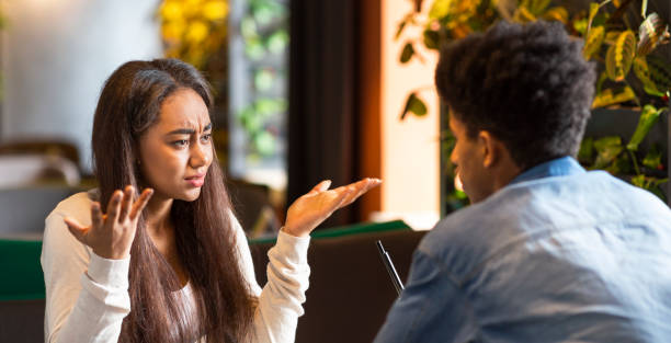 istock Furious young girl desperately looking at afro guy 1172137288