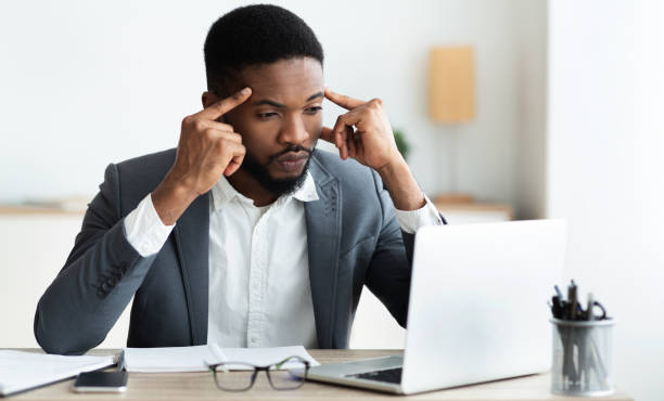 istock Concentrated african employee analyzing information on laptop, working in office 1172137874