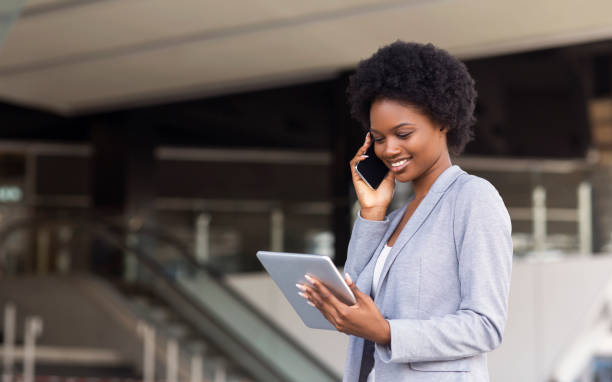 istock Businesswoman making phone call and looking at digital tablet screen 1172138312