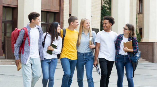 istock College classmates walking outside in campus, panorama 1172138470