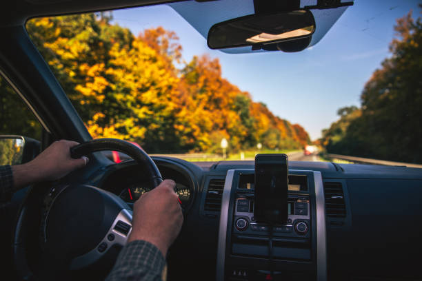 istock man hands on steering wheel riding by autumn speedway fall season 1172138720