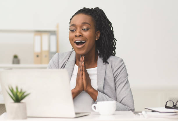 istock Happy Black Office Girl Clasping Hands Sitting At Workplace 1172139495