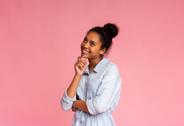 istock Pensive african girl looking upwards on pink studio background 1172139656