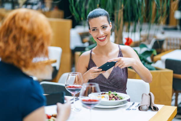 istock Two girlfriends drinking wine and having fun in restaurant 1172139726