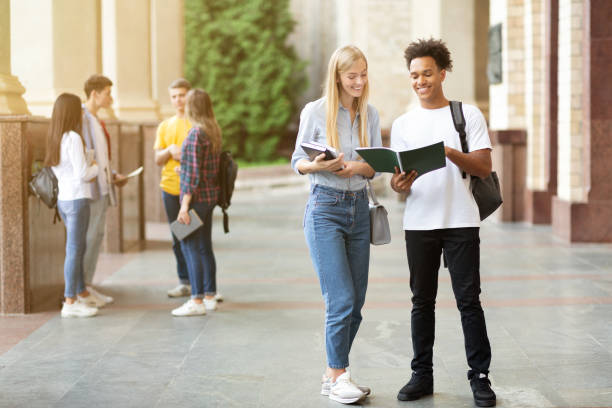 istock Student friends reading book in university campus 1172139811