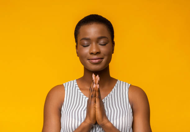 istock Peaceful black girl praying with closed eyes 1172140981