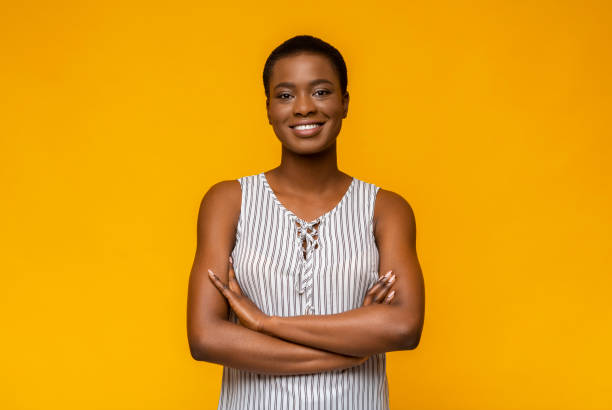 istock Confident african american woman posing on yellow studio background 1172141234