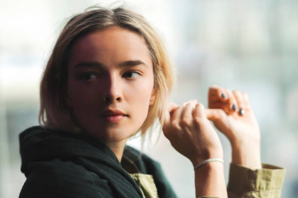 istock Serious looking young woman looking sideways in the shade 1172141875