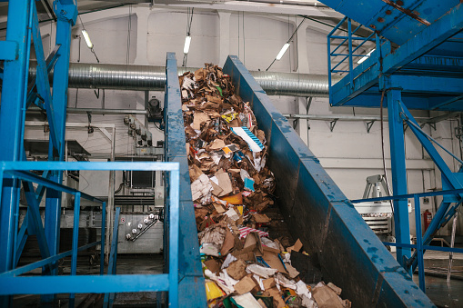 Waste sorting plant. Conveyor on which waste is moving to enter the sorting for further storage and disposal or recycling.