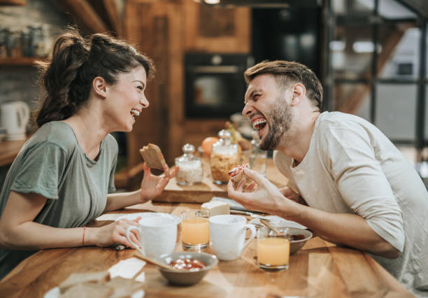 istock Young cheerful couple talking while eating breakfast in the morning. 1172146265