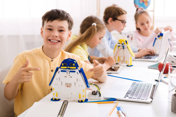 istock Smart boy showing his robot. Proud student of his project 1172147073