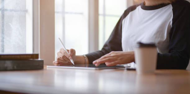 istock Close-up view of female freelancer writing her idea concepts on tablet 1172148456