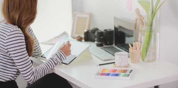 istock Professional designer editing her project with tablet in modern workplace 1172148787