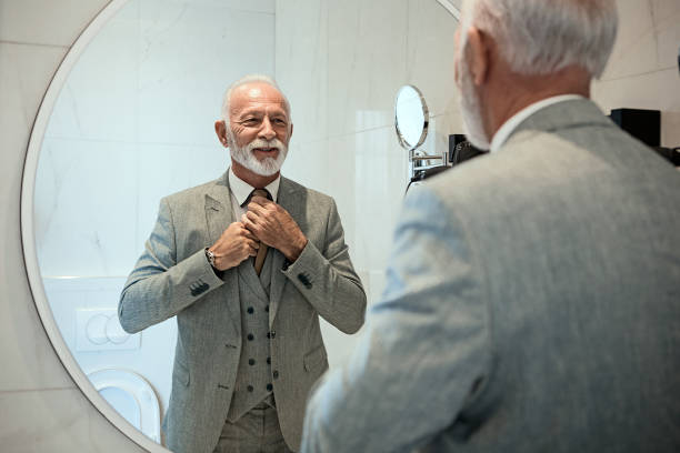 Businessman dressing up in bathroom Businessman dressing up man adjusting tie stock pictures, royalty-free photos & images