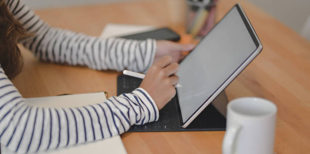 istock Cropped shot of professional female designer working on her project while writing on tablet 1172149147