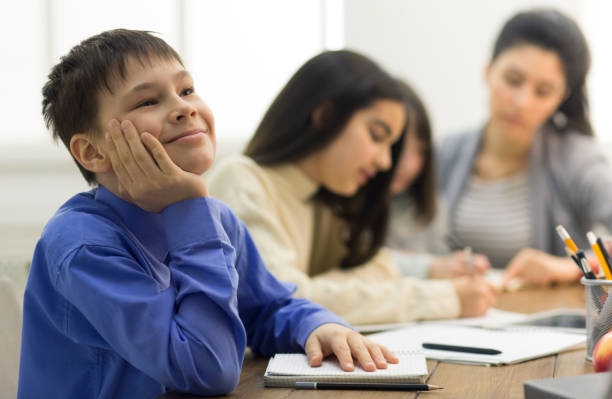 istock Dreamful pupil not paying attention in classroom 1172149172