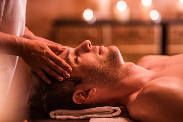 istock Young man receiving head massage at the spa. 1172150701