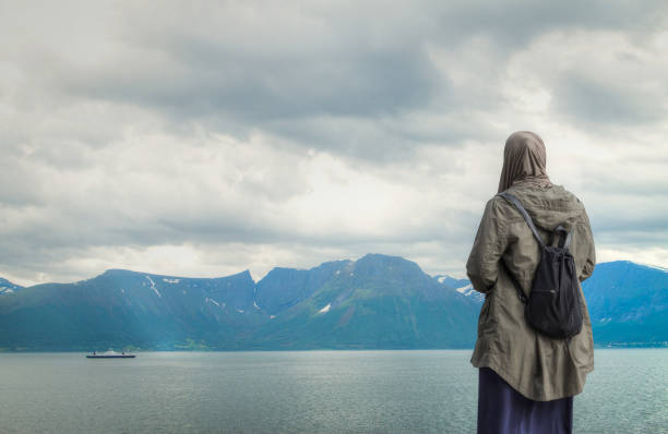 Woman in hijab against the background of the Norwegian fjords
