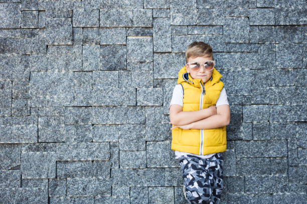 istock Cool kid with arms crossed against the wall. 1172152370
